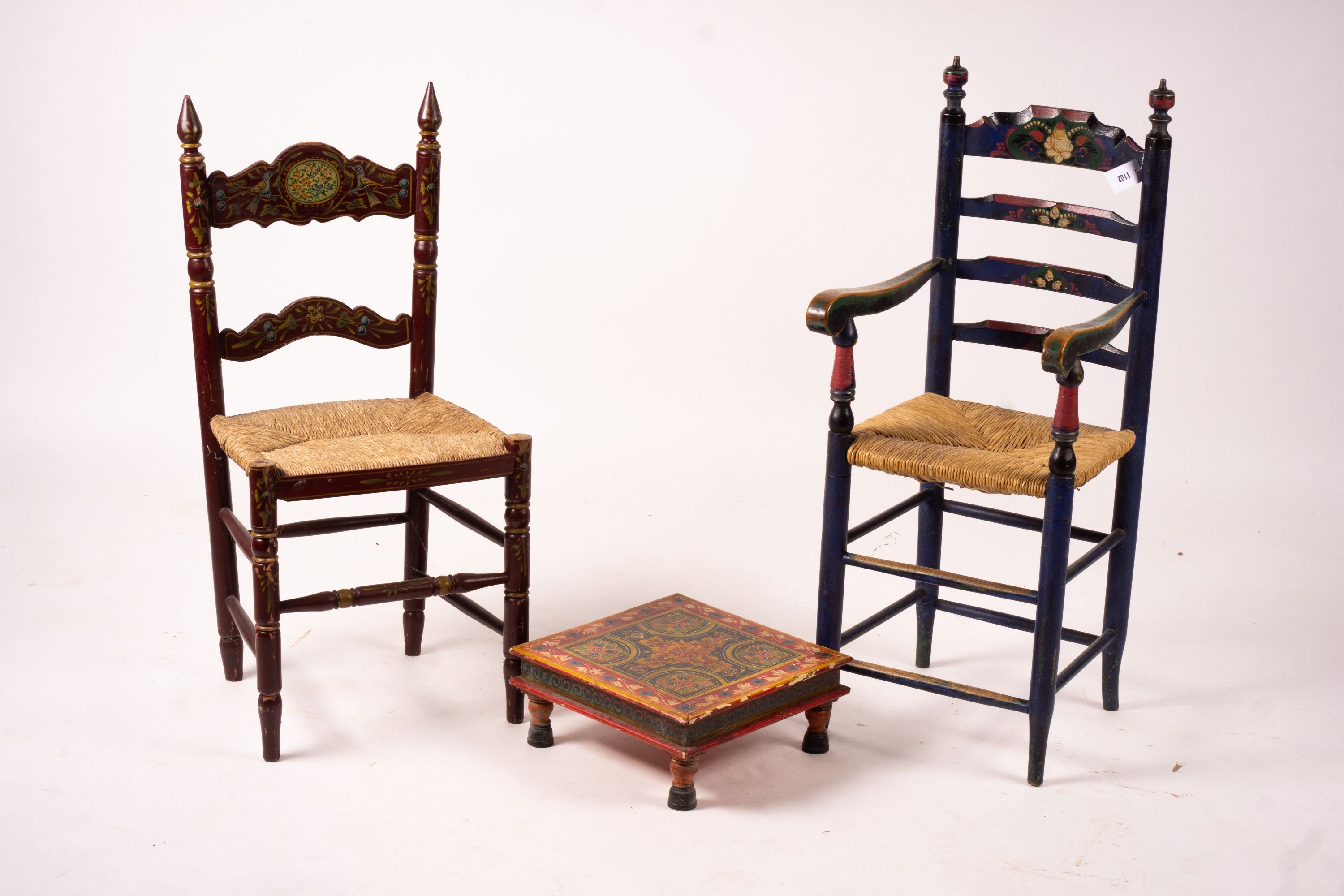 Two 19th / early 20th century Swiss painted rush seat chairs, together with a square low table